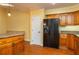 Kitchen features wood cabinets, granite counters and black appliances at 109 Odin Dr, Winter Haven, FL 33884