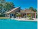 Community pool with lounge chairs and patio furniture at 109 Odin Dr, Winter Haven, FL 33884