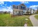 Two-story home with blue shutters, stone accents, and a welcoming front porch at 3028 Park Vale Rd, Saint Cloud, FL 34771