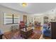 Bright and airy living room with hardwood floors, and ample natural light at 466 Muirfield Ct, Winter Haven, FL 33884