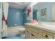 Clean bathroom with blue tile, a shower/tub combo, and updated vanity at 466 Muirfield Ct, Winter Haven, FL 33884