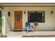 House front entrance with wood door and porch at 466 Muirfield Ct, Winter Haven, FL 33884