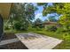Private backyard with patio, lush landscaping, and a fenced area at 466 Muirfield Ct, Winter Haven, FL 33884