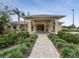 Community clubhouse entrance with covered walkway at 466 Muirfield Ct, Winter Haven, FL 33884