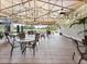 Community patio with tables and chairs, overlooking golf course at 466 Muirfield Ct, Winter Haven, FL 33884