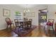 Bright dining room with hardwood floors and chandelier at 466 Muirfield Ct, Winter Haven, FL 33884