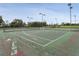 Community tennis courts with fencing and lighting at 466 Muirfield Ct, Winter Haven, FL 33884