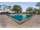 Community swimming pool with lounge chairs and cabana at 466 Muirfield Ct, Winter Haven, FL 33884
