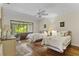 Bright bedroom with two twin beds, hardwood floors, and sliding glass doors to a patio at 466 Muirfield Ct, Winter Haven, FL 33884