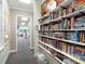 Hallway with built-in bookshelves and access to pro shop at 466 Muirfield Ct, Winter Haven, FL 33884