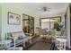 Bright sunroom with seating area, and view of the backyard at 466 Muirfield Ct, Winter Haven, FL 33884