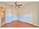 Hardwood floor bedroom with double door closet and access to bathroom at 192 Juliana Ridge Way, Auburndale, FL 33823