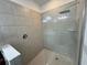 Large walk-in shower with glass enclosure and neutral tile at 13515 Lake Yale View Loop, Grand Island, FL 32735