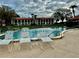 White lounge chairs surrounding the refreshing community pool at 6001 Country Club Dr, Lake Wales, FL 33898