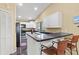 Galley kitchen with breakfast bar and white cabinets at 6001 Country Club Dr, Lake Wales, FL 33898