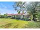 Single story home with red tile roof and lawn at 6001 Country Club Dr, Lake Wales, FL 33898