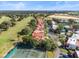 Aerial view of a townhome community near a golf course and tennis courts at 6001 Country Club Dr, Lake Wales, FL 33898