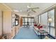 Sunroom with light blue carpet, comfortable seating, and large windows at 6001 Country Club Dr, Lake Wales, FL 33898
