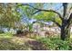 Spanish style home with lush landscaping and mature trees at 6001 Country Club Dr, Lake Wales, FL 33898