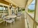 Relaxing community porch with tables and chairs, overlooking a scenic landscape at 627 Watercrest Dr, Haines City, FL 33844