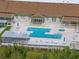 Community pool with lounge chairs and umbrellas at 627 Watercrest Dr, Haines City, FL 33844
