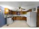 Galley kitchen with wood cabinets, appliances, and tiled floor at 6426 Jenny Dr, Lake Wales, FL 33898