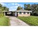 Brick ranch house with carport and yard at 6426 Jenny Dr, Lake Wales, FL 33898