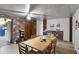 Dining room with wood table and chairs, brick accent wall at 6426 Jenny Dr, Lake Wales, FL 33898