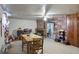 Dining area with wood table and chairs, brick fireplace, and access to kitchen at 6426 Jenny Dr, Lake Wales, FL 33898