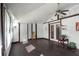 Bright sunroom features dark flooring, ceiling fan, and multiple windows at 6426 Jenny Dr, Lake Wales, FL 33898