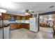 Kitchen features wood cabinets, tiled floor and view of dining area at 6426 Jenny Dr, Lake Wales, FL 33898