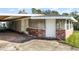 House exterior with carport, brick accents and landscaping at 6426 Jenny Dr, Lake Wales, FL 33898