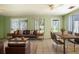 Bright sunroom features a comfortable seating area and a dining table, perfect for relaxation and entertaining at 672 Wakulla Dr, Winter Haven, FL 33884