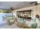 Relaxing patio with wicker furniture and a glass-top coffee table offers a peaceful outdoor space at 672 Wakulla Dr, Winter Haven, FL 33884