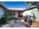 Front entrance with a red door and a walkway leading to the house at 672 Wakulla Dr, Winter Haven, FL 33884