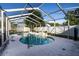 Inviting kidney-shaped swimming pool with a screened enclosure and a concrete deck at 672 Wakulla Dr, Winter Haven, FL 33884