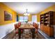 Elegant dining room with a large wooden table and leather chairs offers a sophisticated setting at 672 Wakulla Dr, Winter Haven, FL 33884