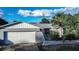 House exterior with white garage door and red front door at 672 Wakulla Dr, Winter Haven, FL 33884