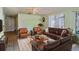 Cozy living room with leather furniture and a large rug creates a welcoming atmosphere at 672 Wakulla Dr, Winter Haven, FL 33884