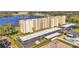 Aerial view of a condo building with lake views, parking, and a pool at 700 Mirror Nw Ter # 508, Winter Haven, FL 33881