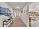 Bright hallway leading to community spaces like a library and lounge at 700 Mirror Nw Ter # 508, Winter Haven, FL 33881