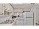 Small condo kitchen with white cabinets and lake view at 700 Mirror Nw Ter # 508, Winter Haven, FL 33881