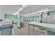 Well-equipped laundry room featuring several washers and dryers at 700 Mirror Nw Ter # 508, Winter Haven, FL 33881