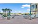 Relaxing pool area with lounge chairs and water views at 700 Mirror Nw Ter # 508, Winter Haven, FL 33881