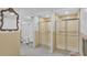 Community showers with glass doors and grab bars at 700 Mirror Nw Ter # 508, Winter Haven, FL 33881