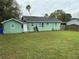 Large grassy backyard with a partially visible wooden fence at 813 Interlachen Pkwy, Lakeland, FL 33801