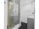 Modern bathroom with a walk-in shower, hexagon tile floor, and gray vanity at 430 N Omaha St, Lake Hamilton, FL 33851