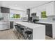 Modern kitchen with white countertops, gray cabinets, and stainless steel appliances at 430 N Omaha St, Lake Hamilton, FL 33851