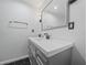 Modern bathroom with gray vanity, white countertop, and hexagon floor tiles at 430 N Omaha St, Lake Hamilton, FL 33851