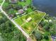 Aerial view of a single-story home on a large lot with a lake view at 430 N Omaha St, Lake Hamilton, FL 33851